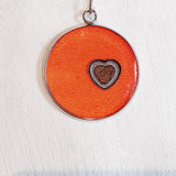 Colourful pendants with a heart and added sand from Cornwall.