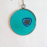 Colourful pendants with a heart and added sand from Cornwall.