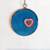 Colourful pendants with a heart and added sand from Cornwall.