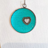 Colourful pendants with a heart and added sand from Cornwall.